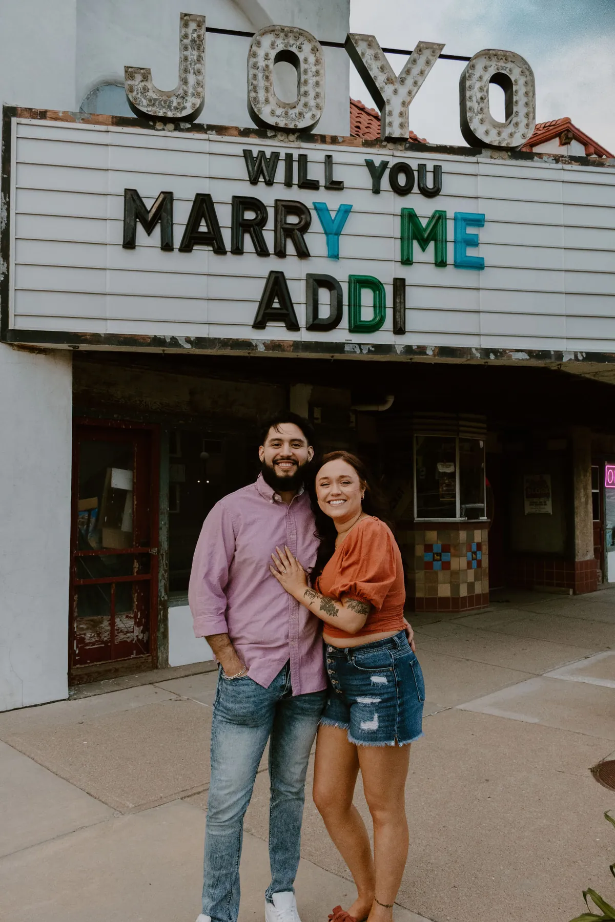 Addi and Geo together under the Joyo marquee after she said yes